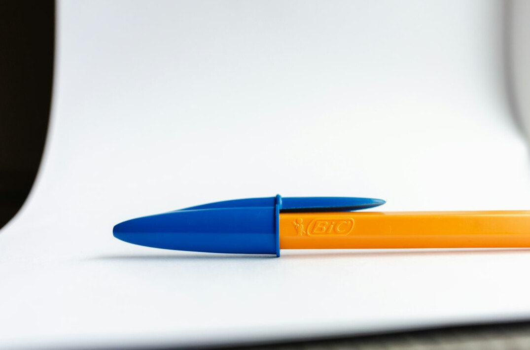 Notebook with handwritten notes and a pen on a desk