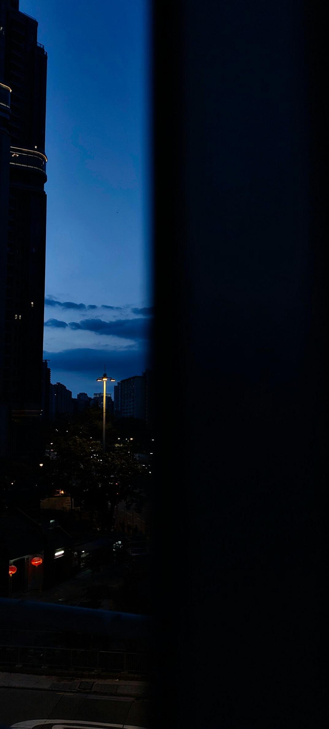 City at night with lights and a moody blue sky